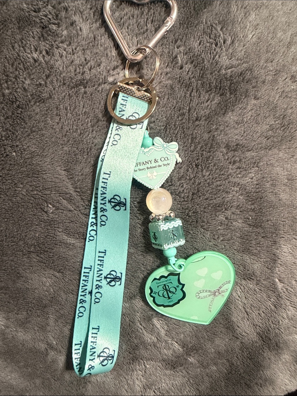 Teal blue heart keychain with charm.